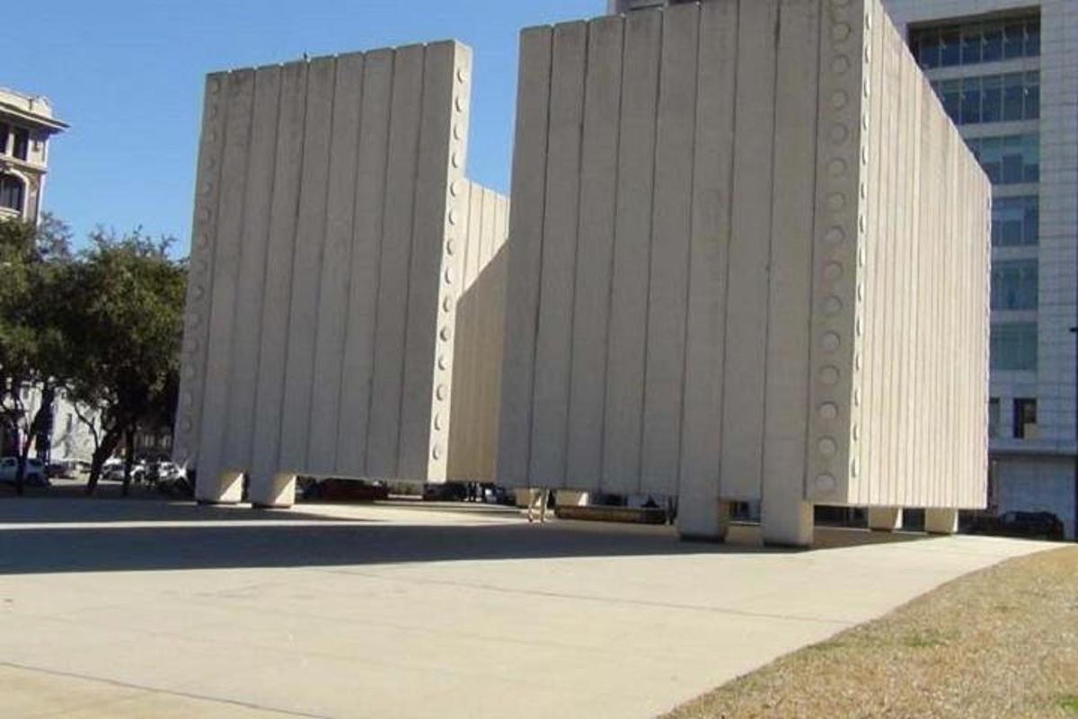 two tall white buildings in front of a building