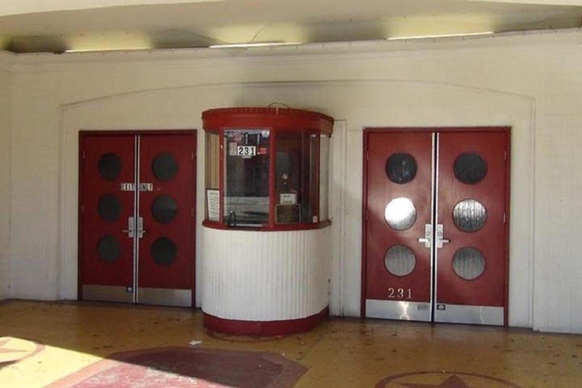 a room with two red doors and a machine
