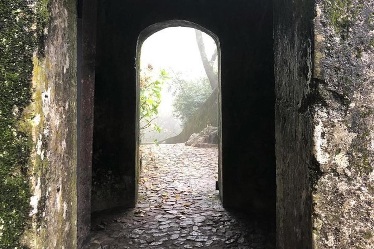 um arco em um edifício com um caminho de pedra