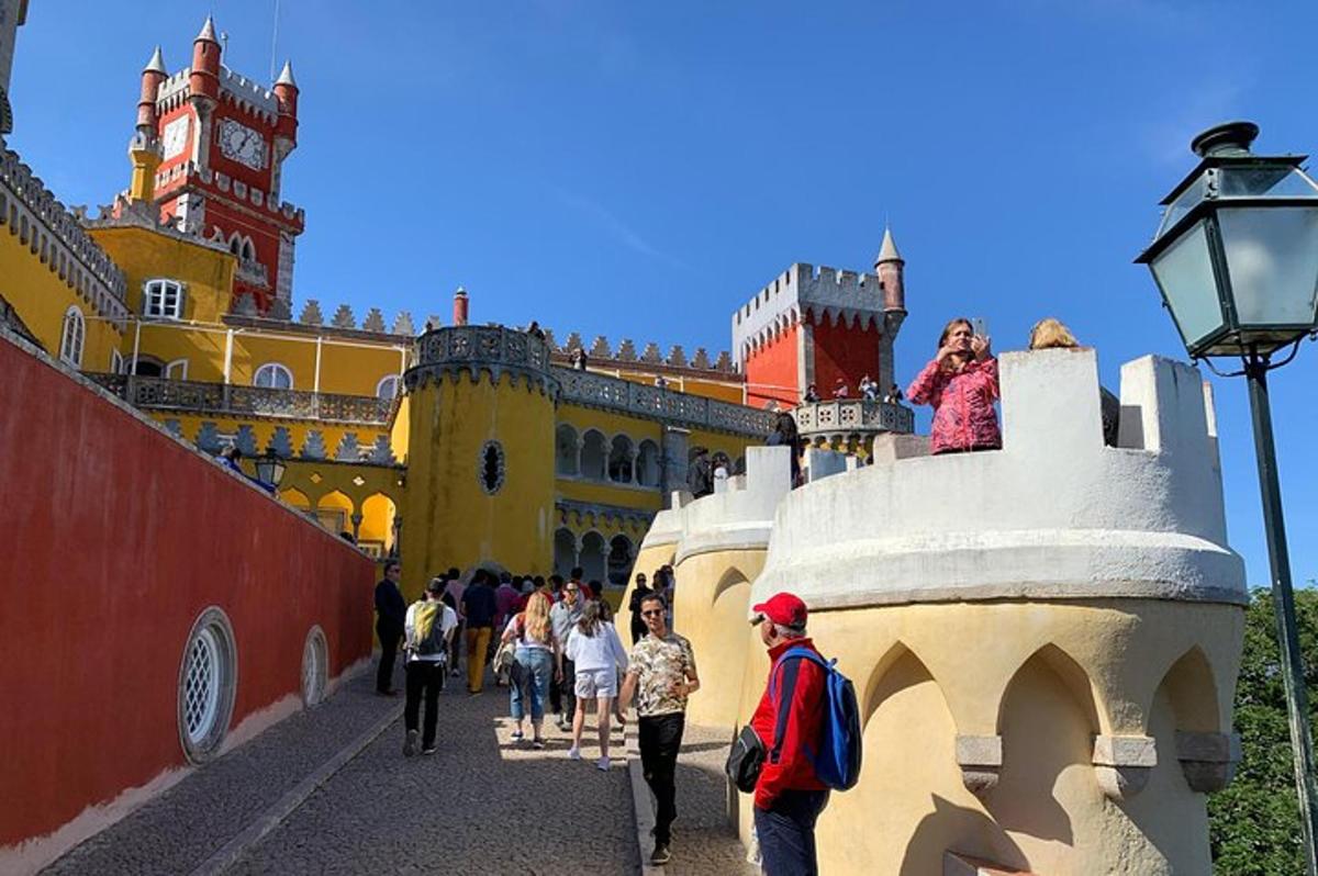 a group of people walking in front of a castle