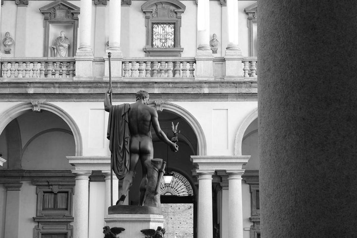 uma estátua de um homem em pé em frente a um prédio