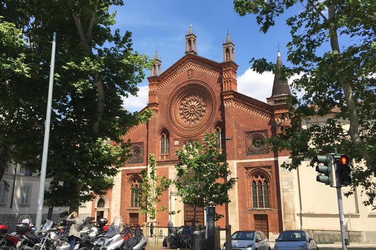 una grande chiesa in mattoni con motociclette parcheggiate di fronte