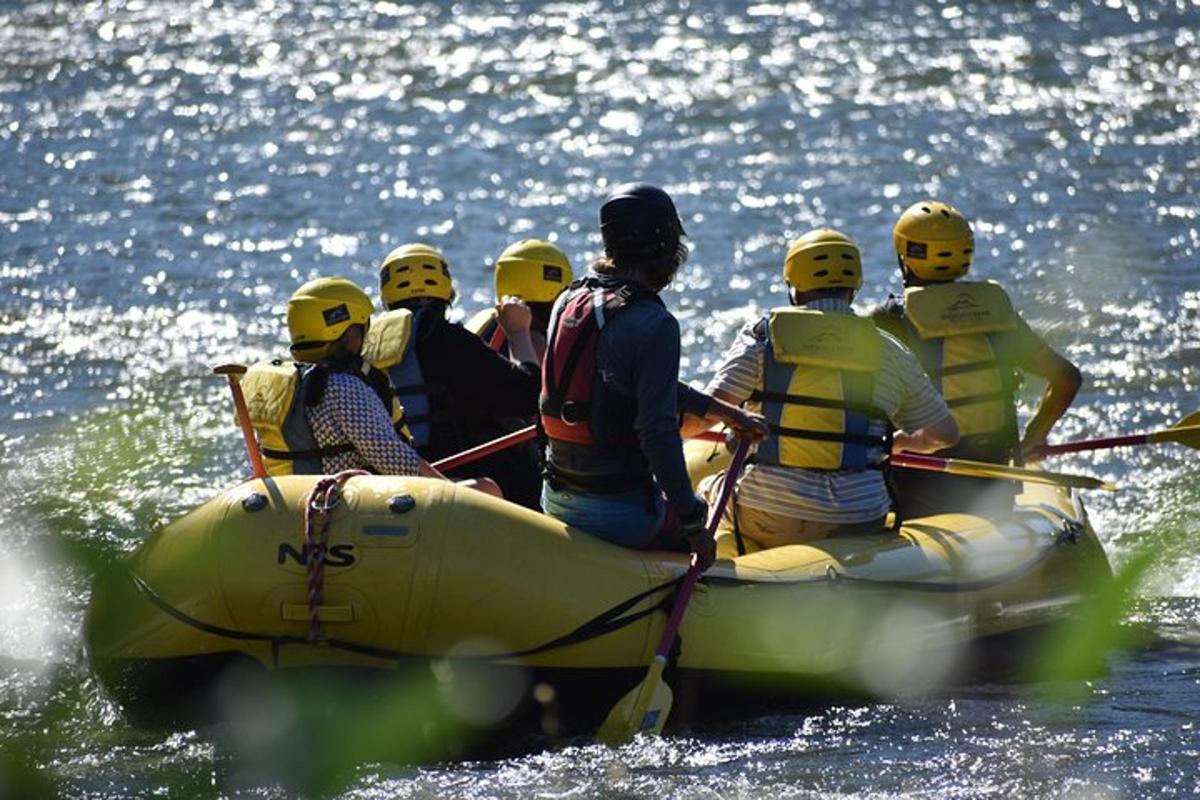 a group of people in a raft in the water