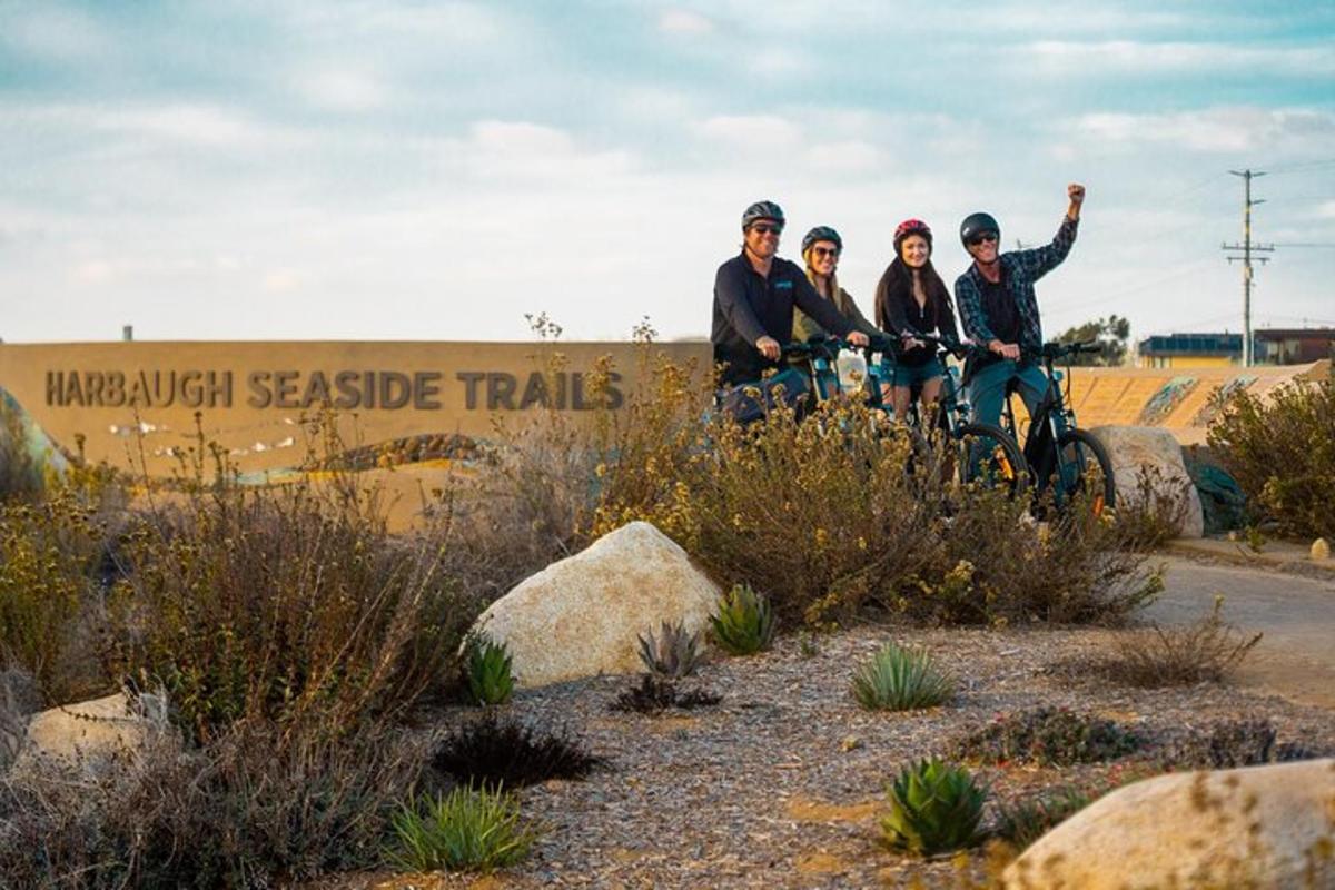 a group of people riding bikes in front of a sign
