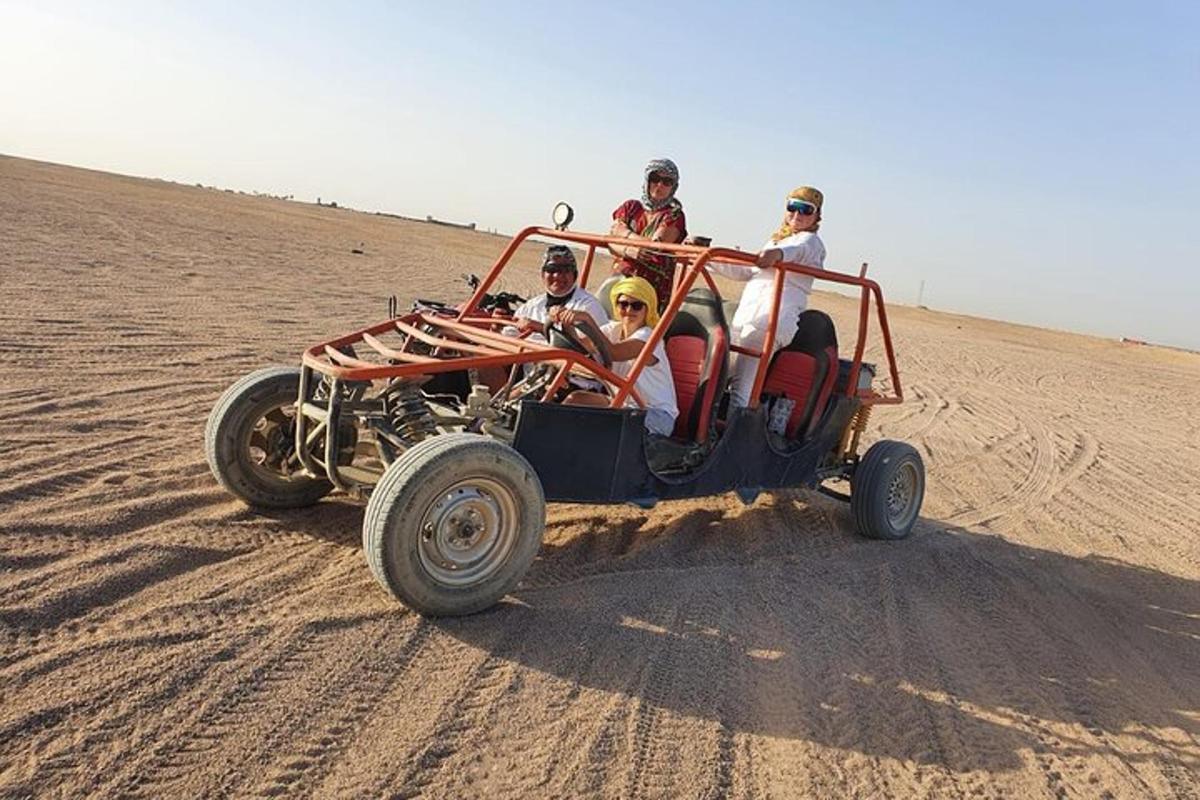 a group of people riding a four wheeler in the desert