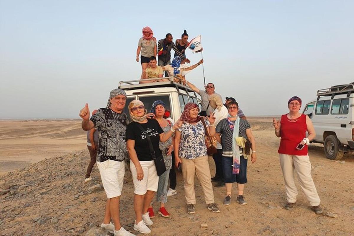 a group of people posing for a picture in the desert