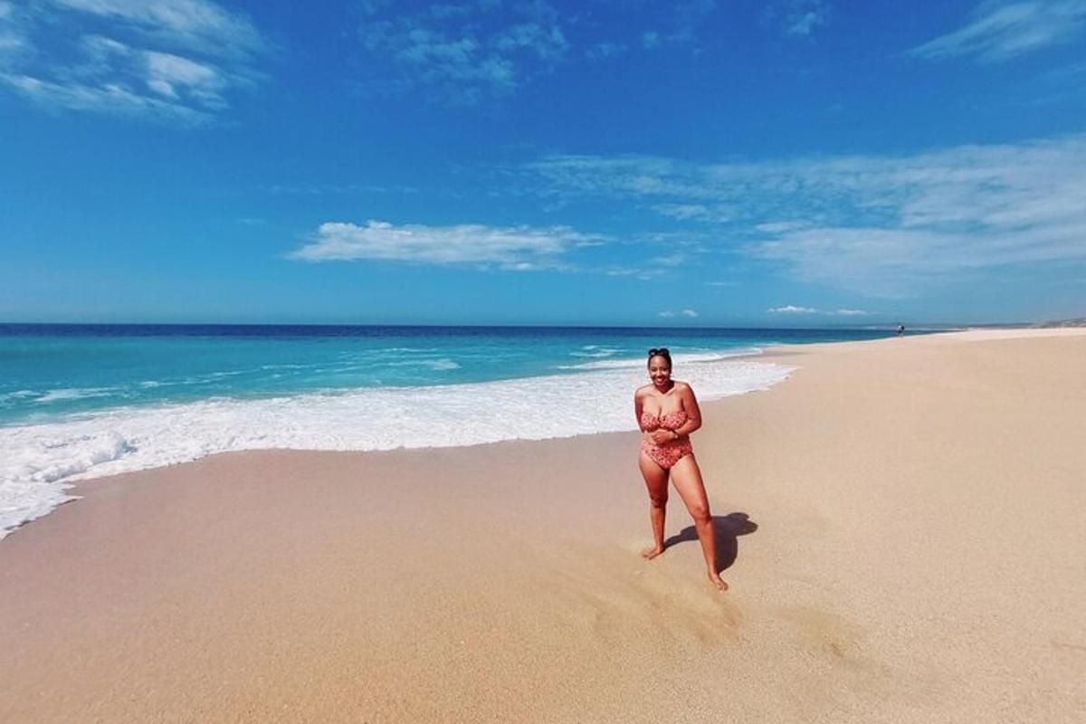 uma mulher de biquíni em pé na praia