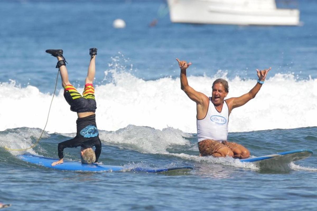 due persone cavalcano un'onda su tavole da surf nell'oceano