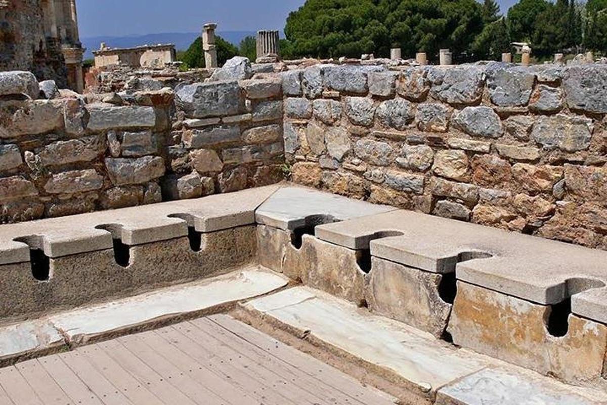 a stone bench in front of a stone wall