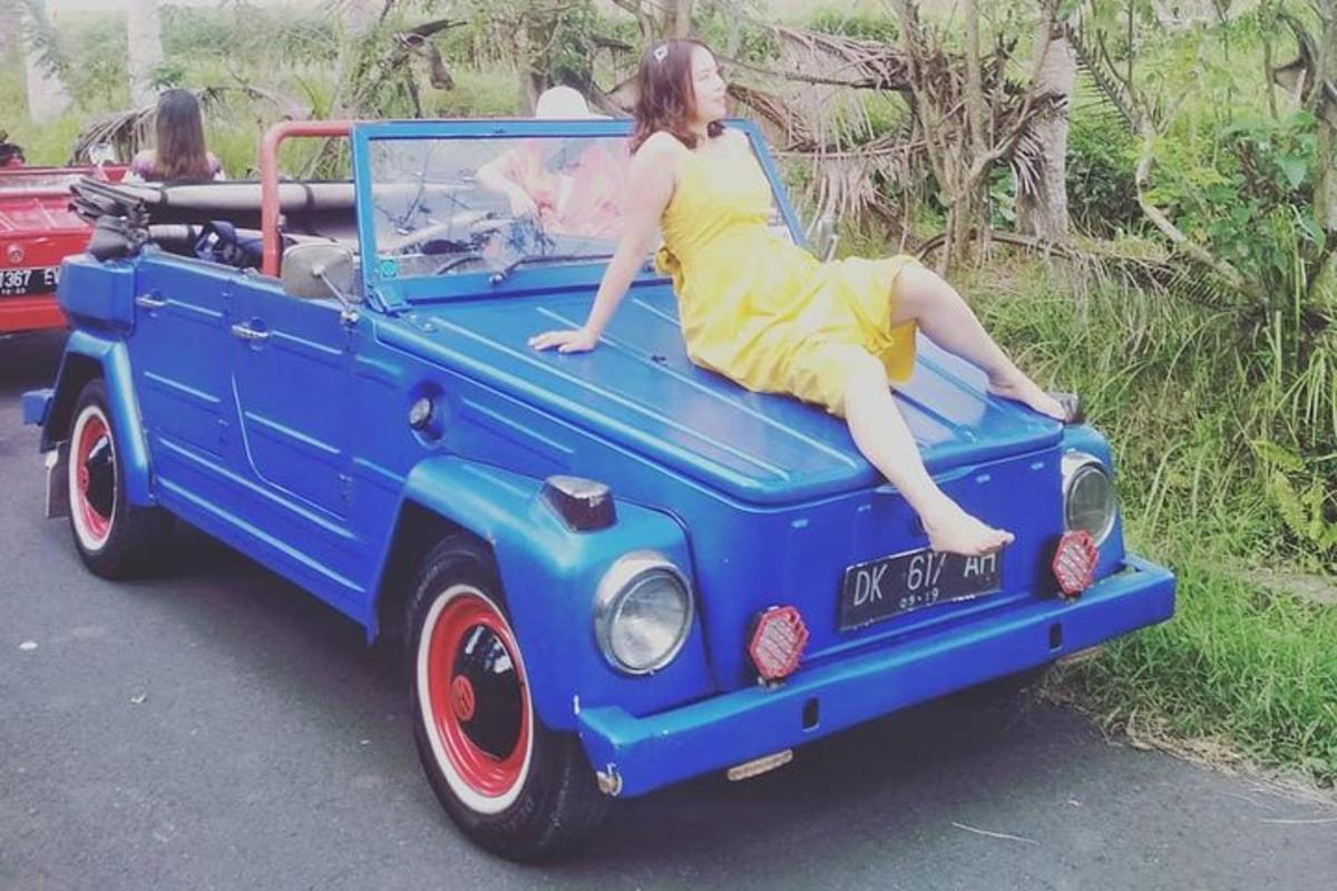 a woman laying on the back of a blue truck