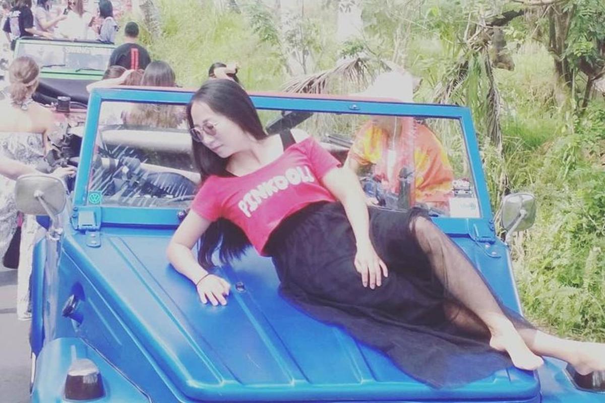 a young girl laying on the back of a blue truck