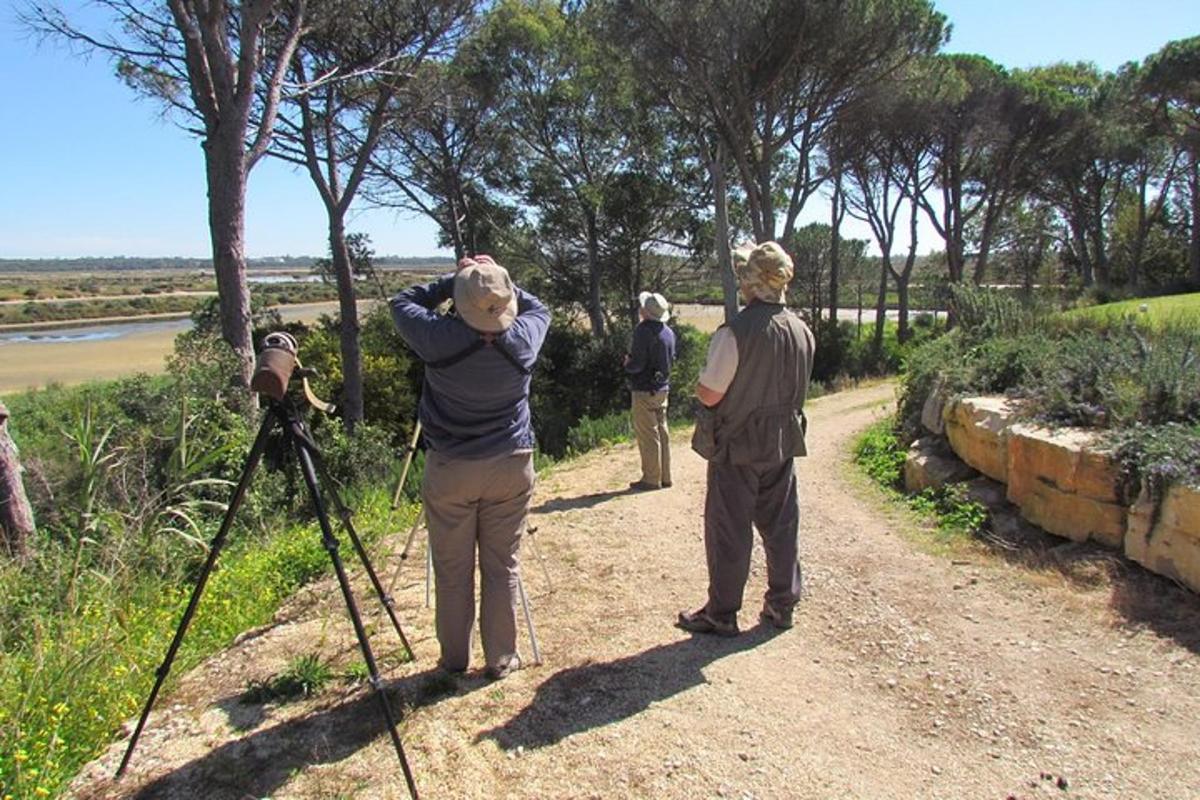 a group of people standing on a dirt road with a camera