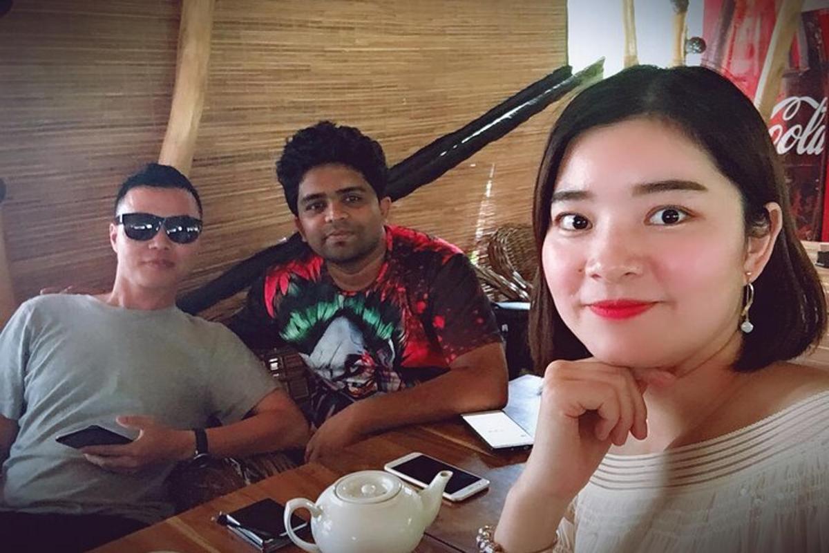 a group of three people sitting at a table