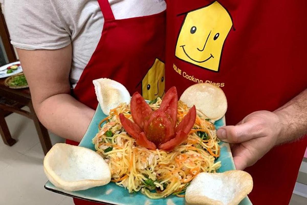 inimene, kes hoiab käes taldrikut krevettidega spagette