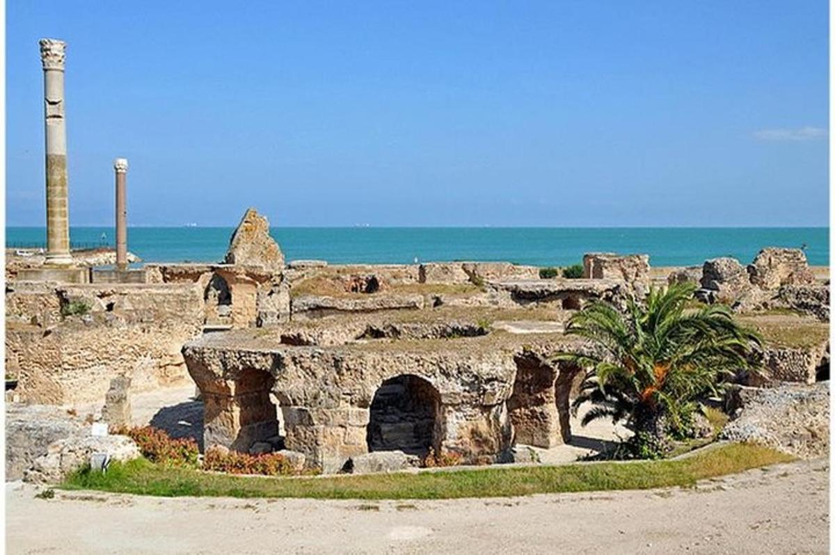 an ancient building with a pillar and the ocean