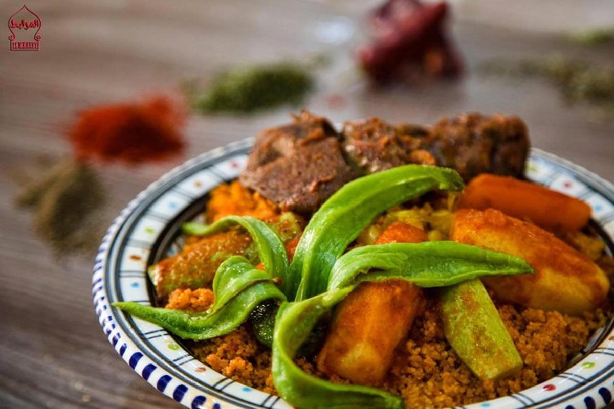 a plate of food with meat and vegetables on a table
