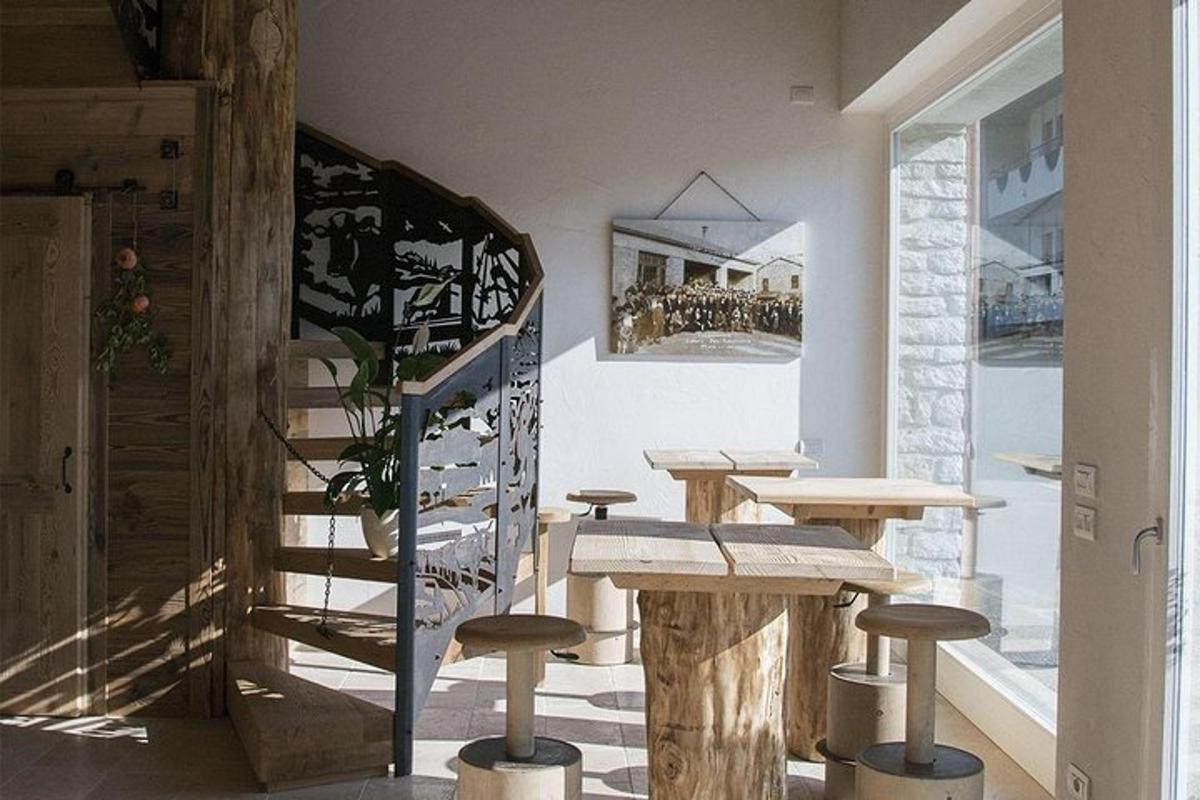 a room with tables and stools and a staircase