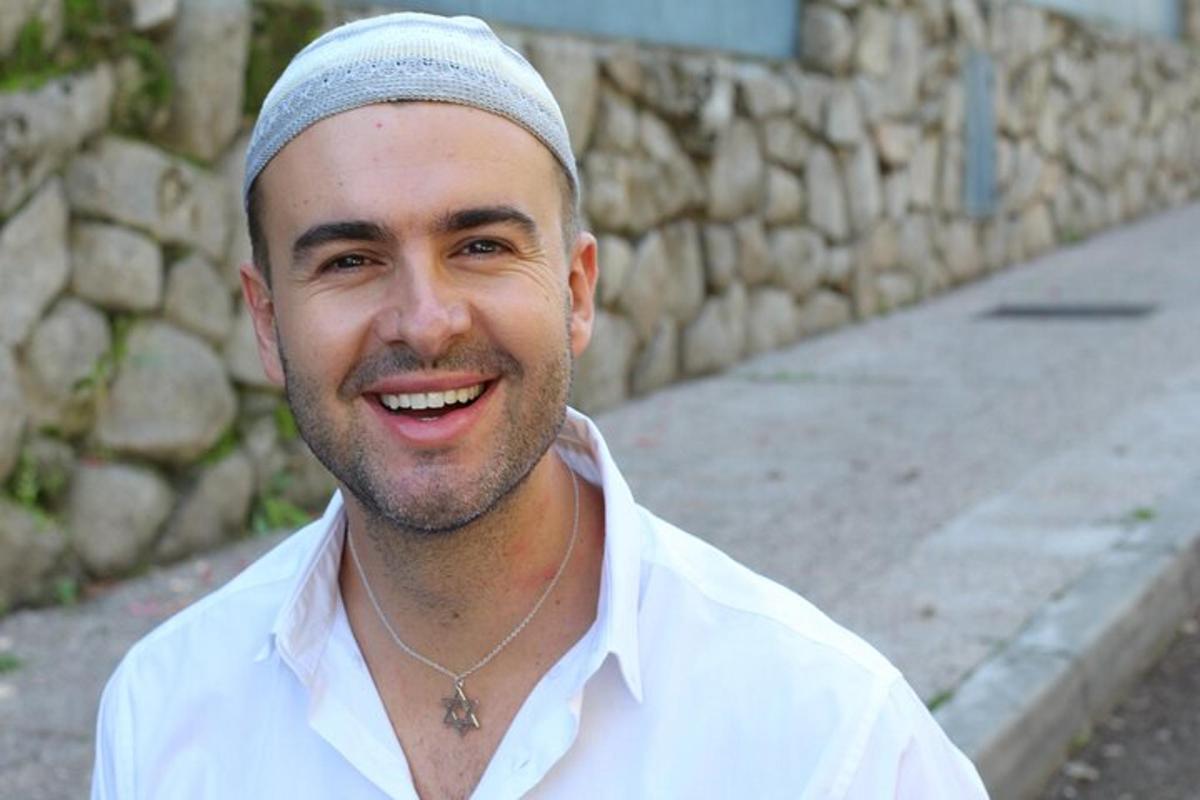 a man is smiling while wearing a bandanna on his head