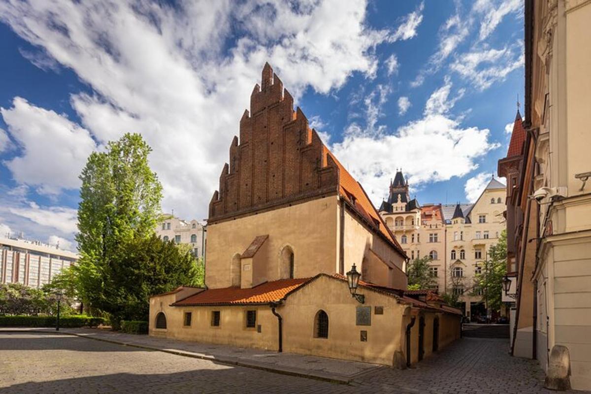 a church with a tower on the side of a street