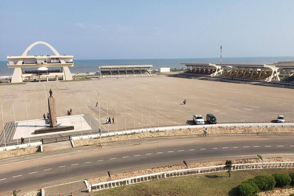 a road next to a large parking lot next to the ocean