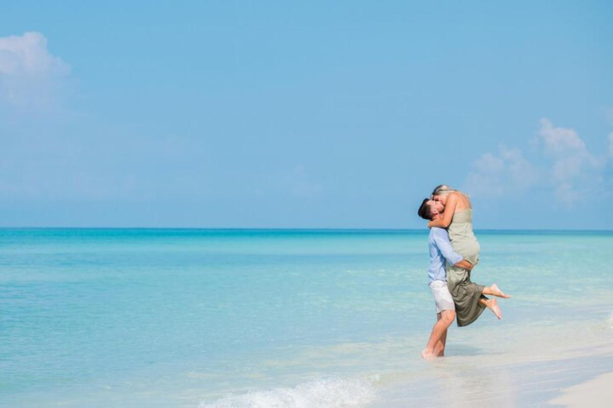 a man carrying a woman on the beach