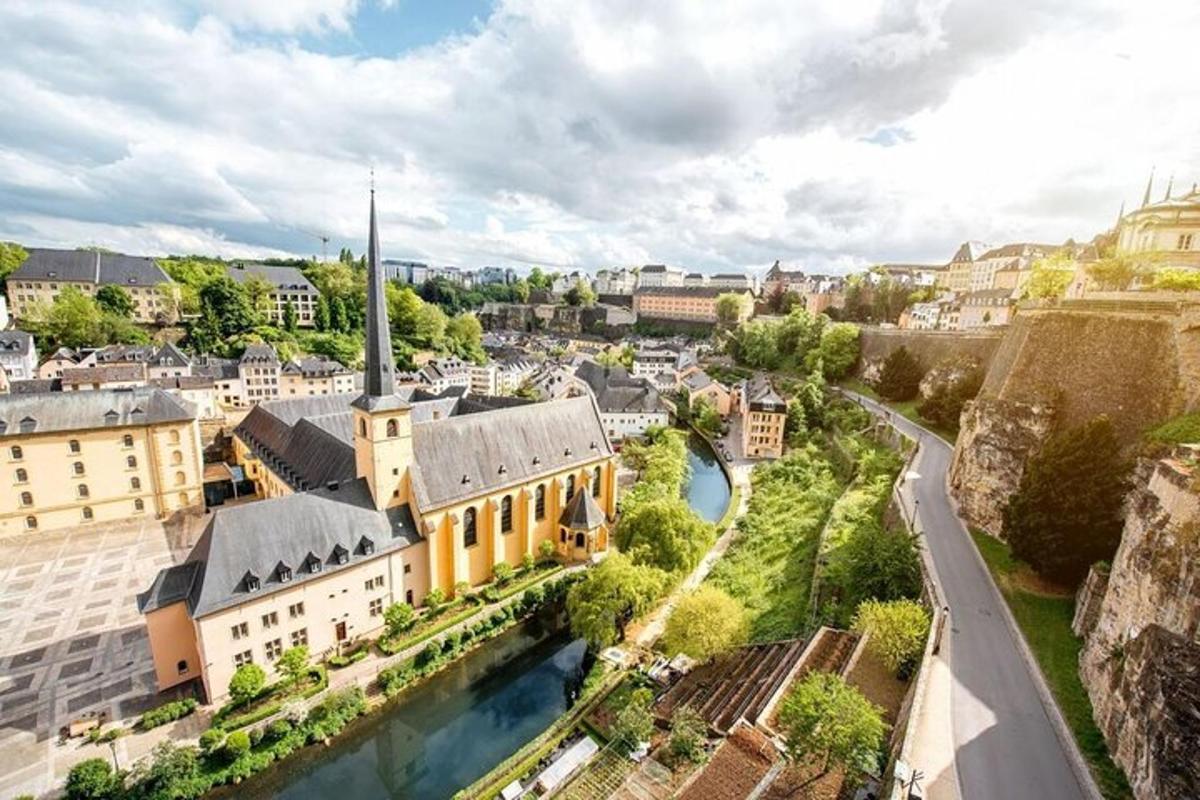 an aerial view of a city with a river and buildings