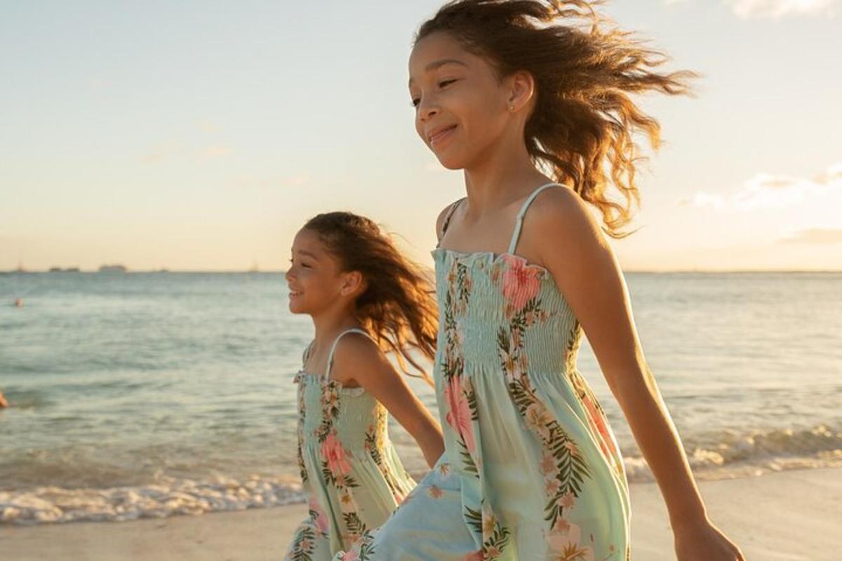 two young girls walking on the beach
