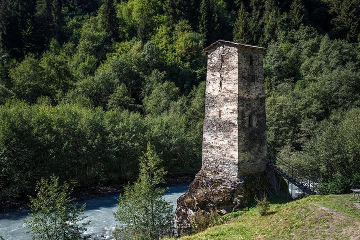 a stone tower sitting on the side of a river
