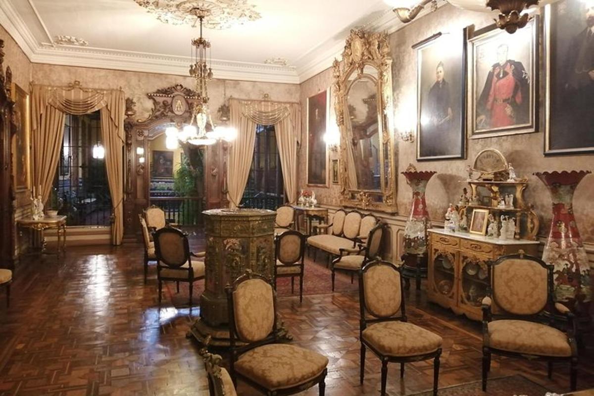 велика кімната зі стільцями та портретами на стінах