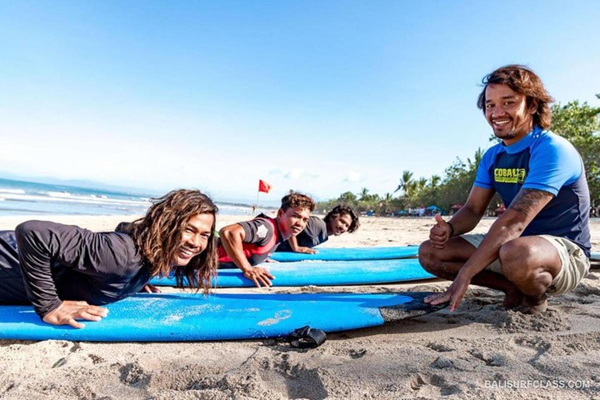 a group of people laying on surfboards on the beach