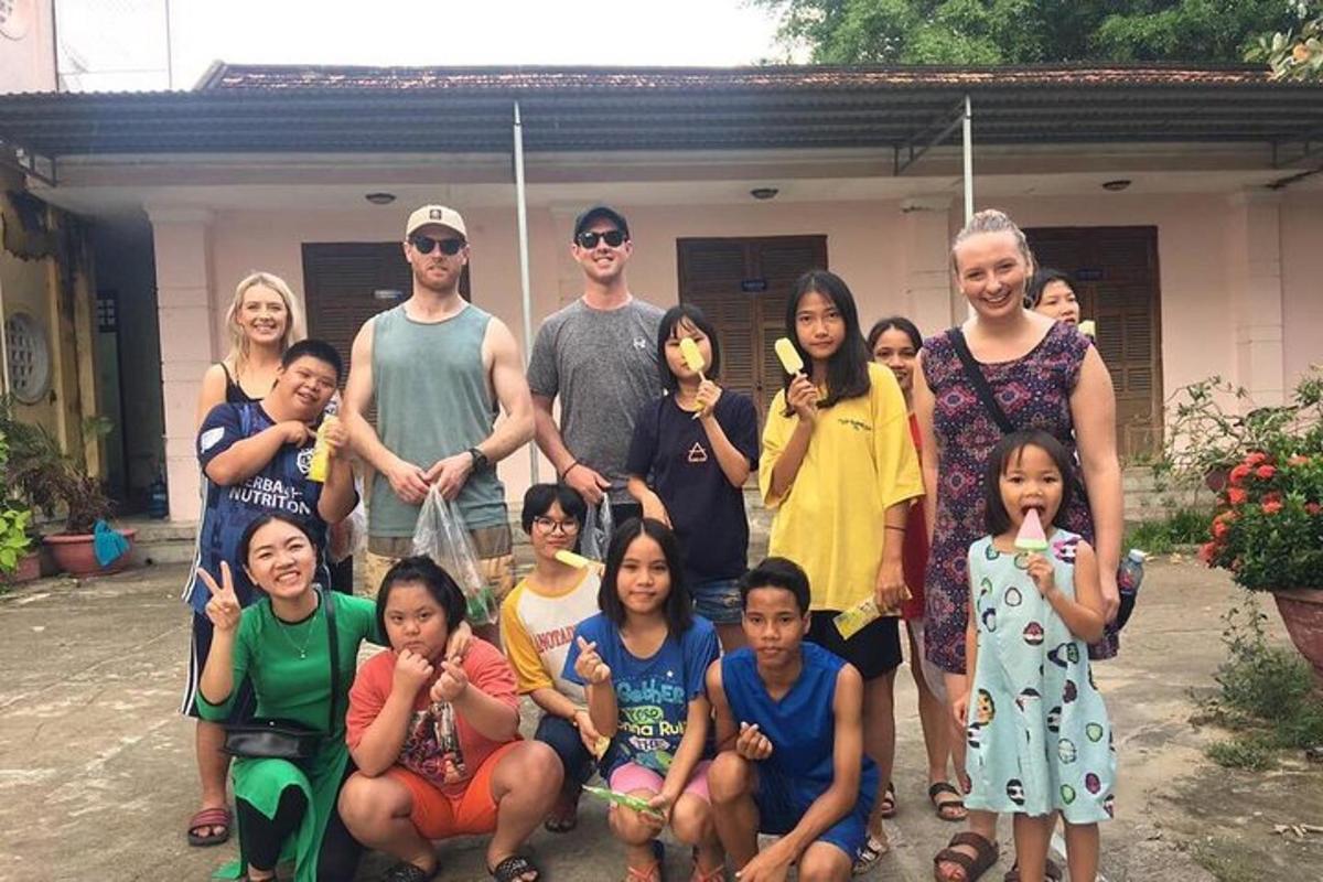 a family posing for a picture in front of a house