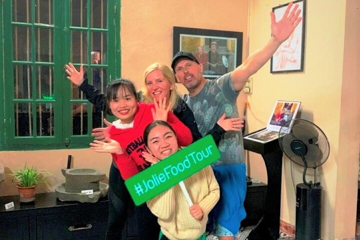 a family posing for a picture with a green sign