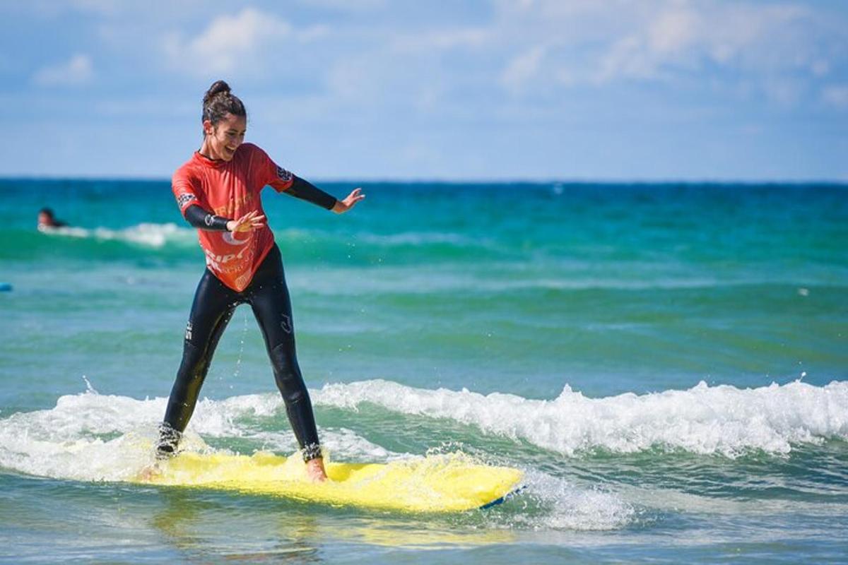 a man riding a wave on a yellow surfboard in the ocean