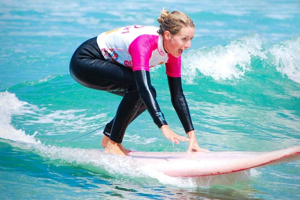 a woman riding a wave on a surfboard in the ocean