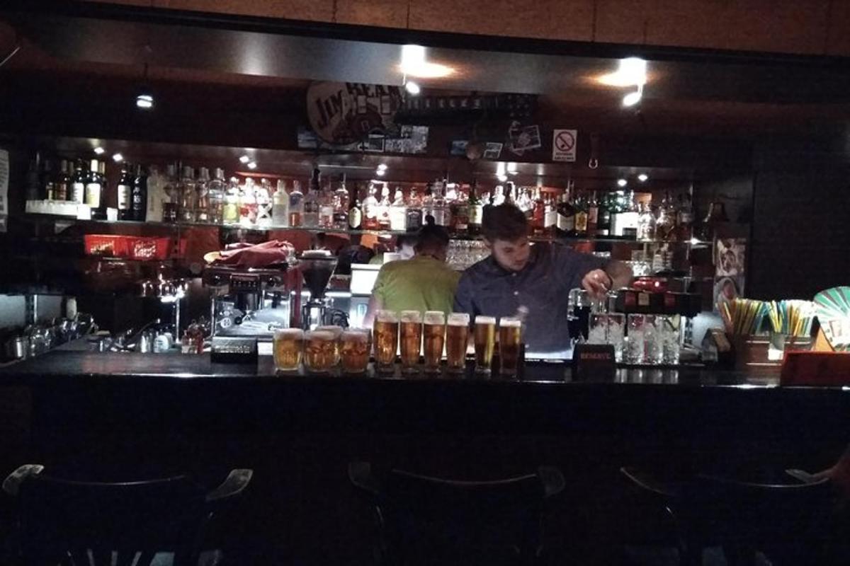 a man standing behind a bar in a restaurant
