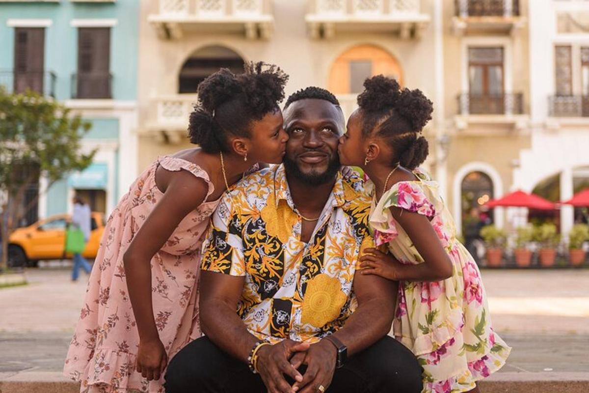 a man is hugging two women on a street