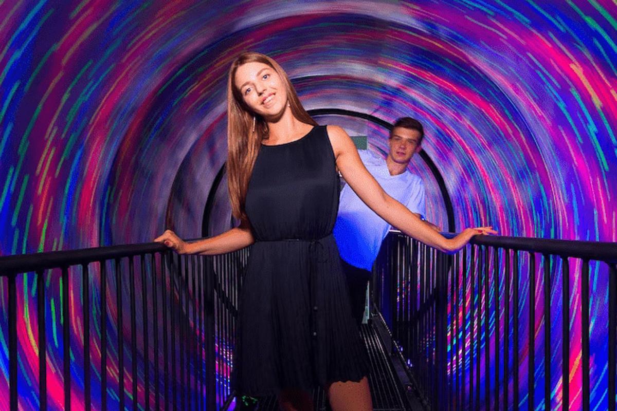 a man and a woman standing in a tunnel