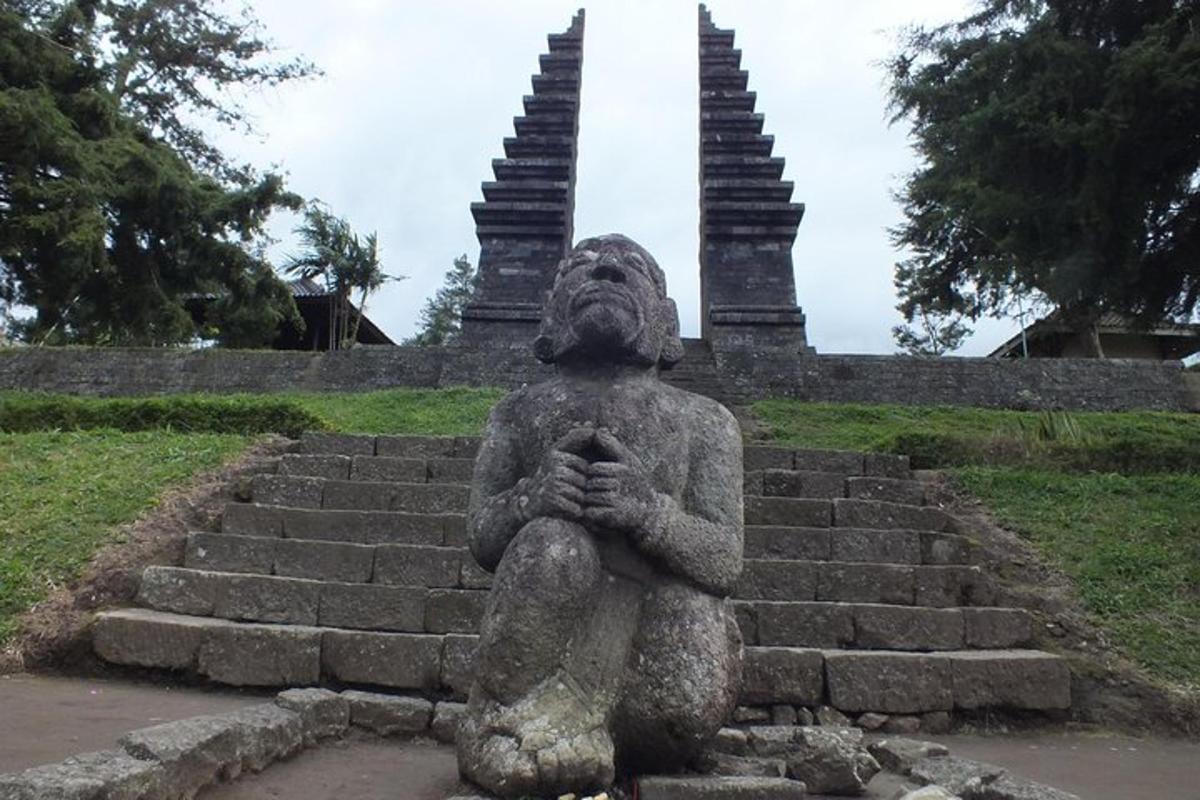 a statue of a person sitting on some steps