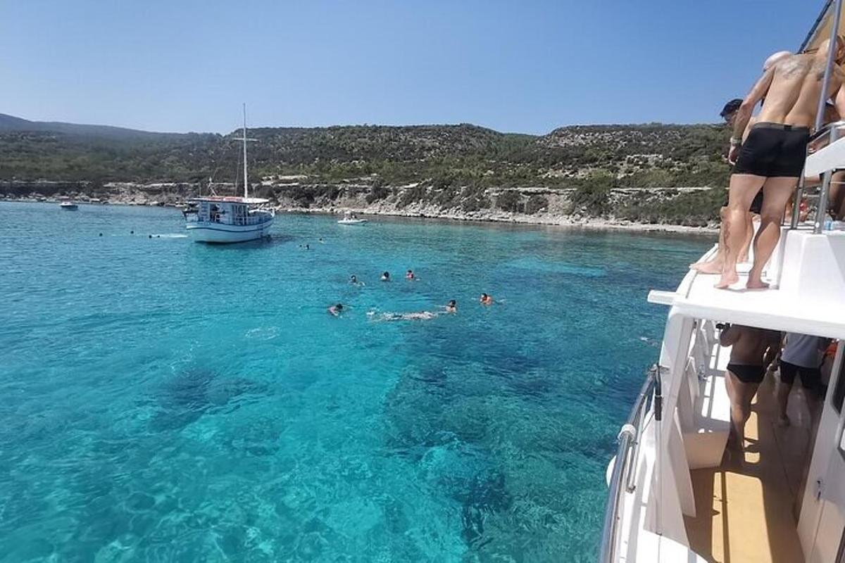 a group of people swimming in the water on a boat