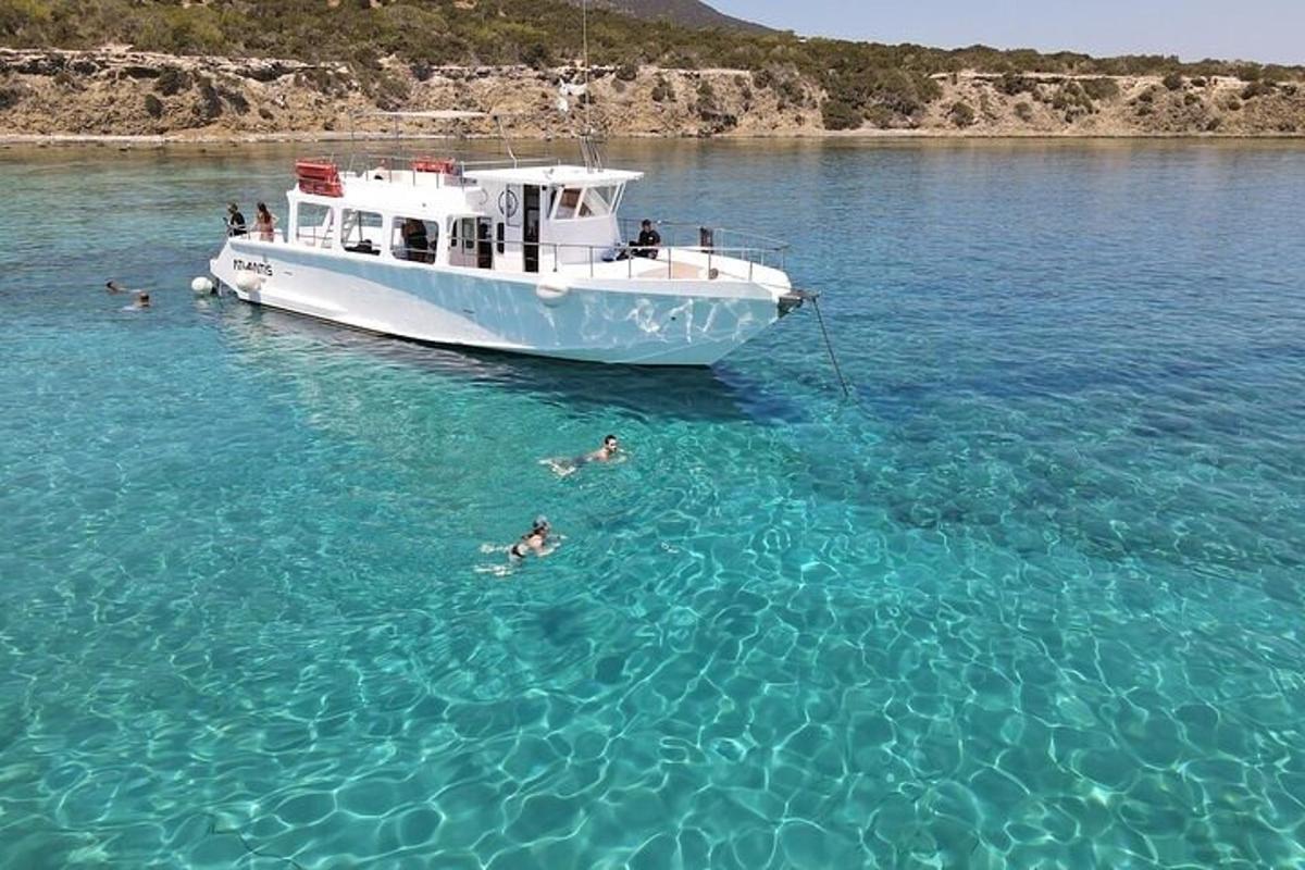a boat in the water with people swimming in it