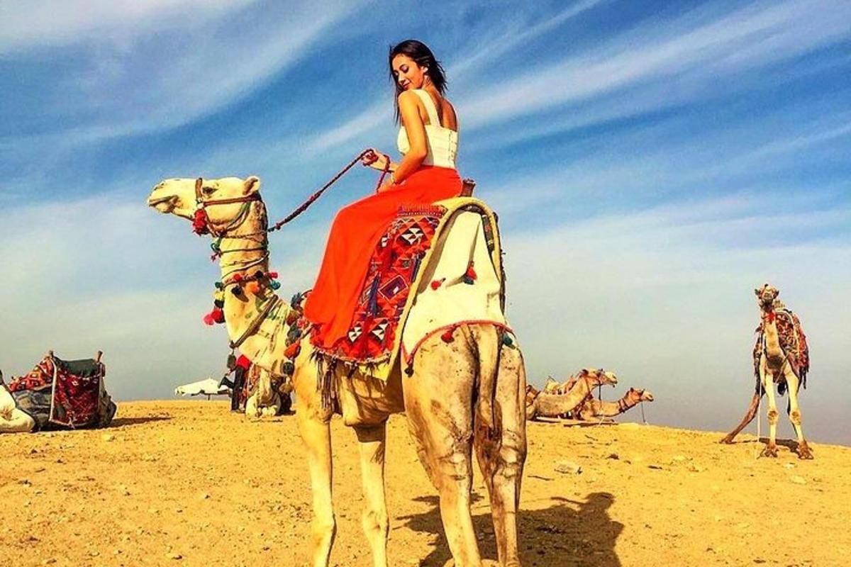 a woman is riding a camel in the desert
