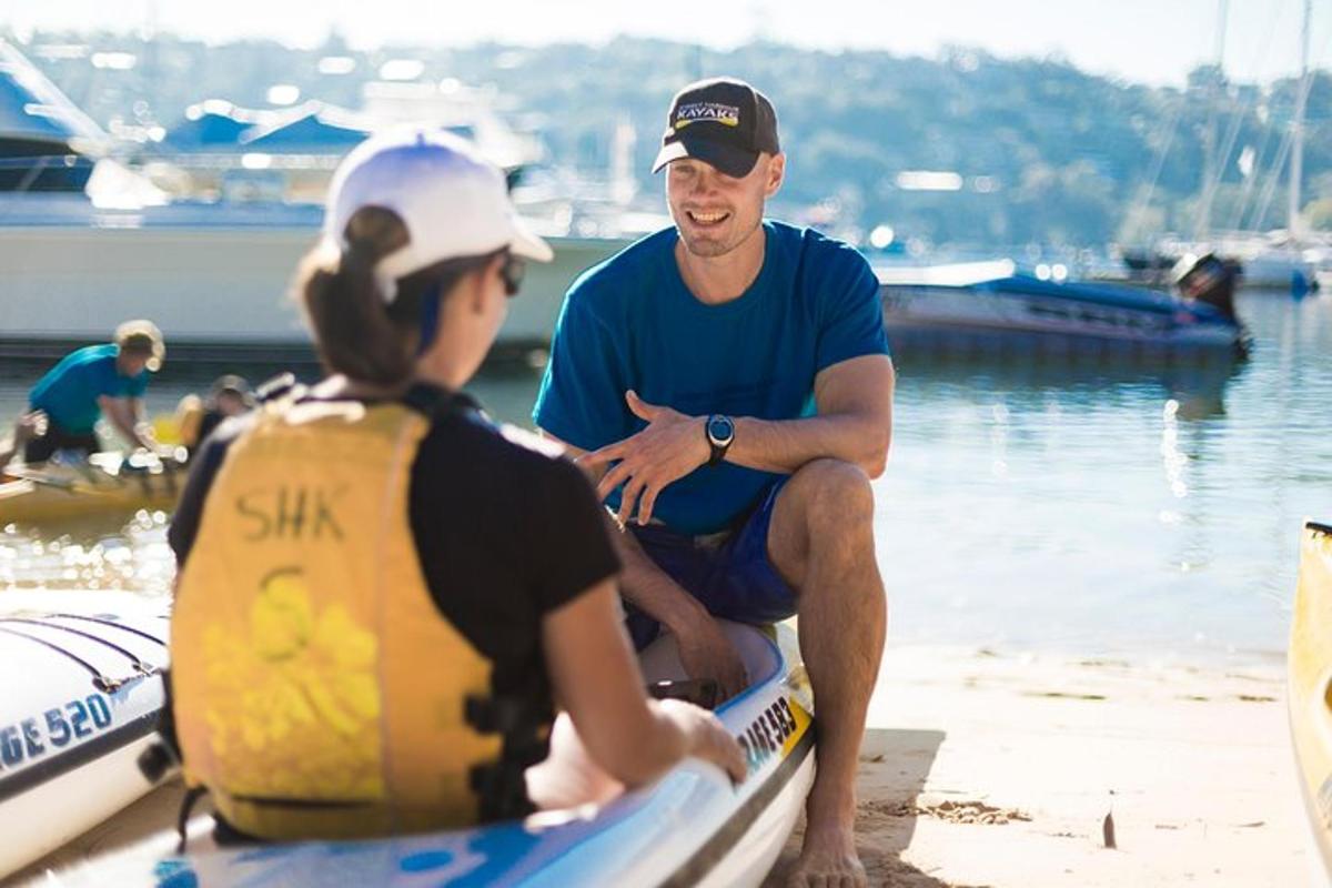 moški in ženska sedita na čolnu na plaži