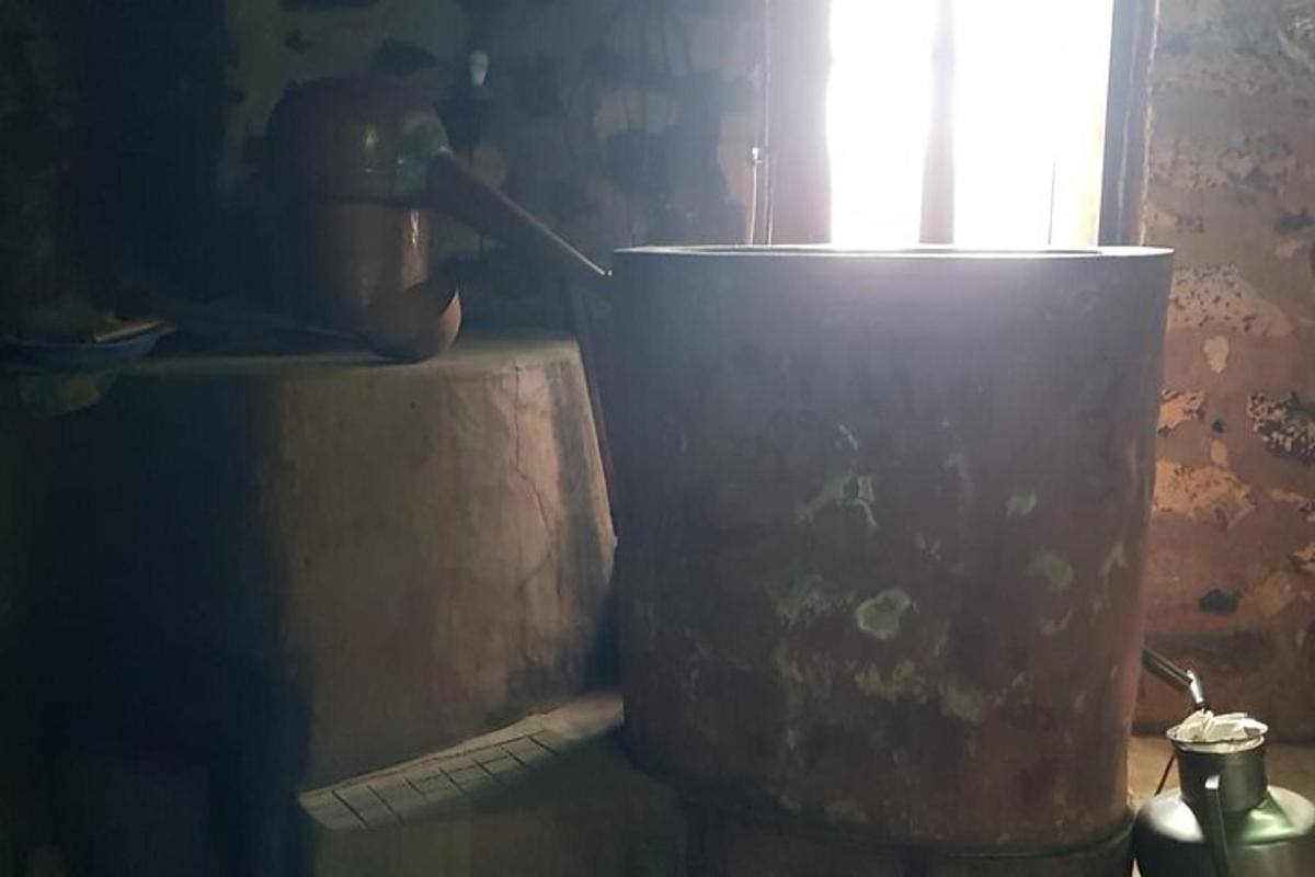 a large pot sitting next to a window in a kitchen