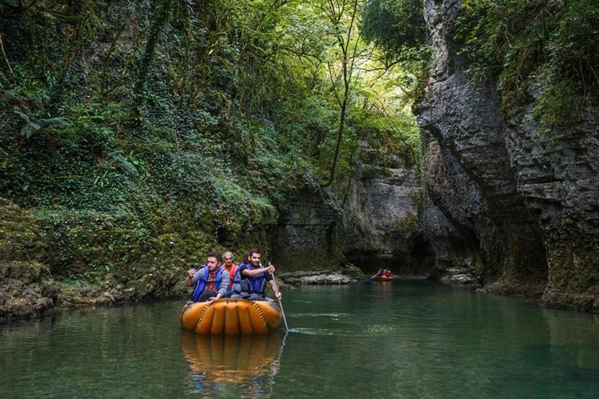 two people are riding in a raft in the water