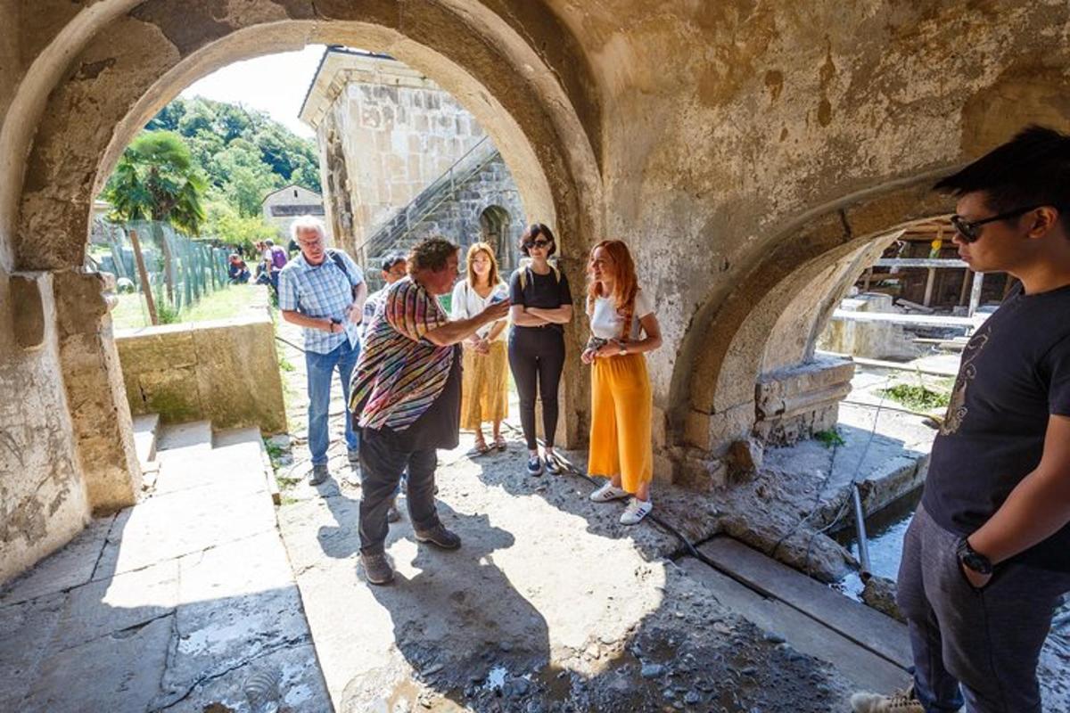 a group of people standing in an arch way