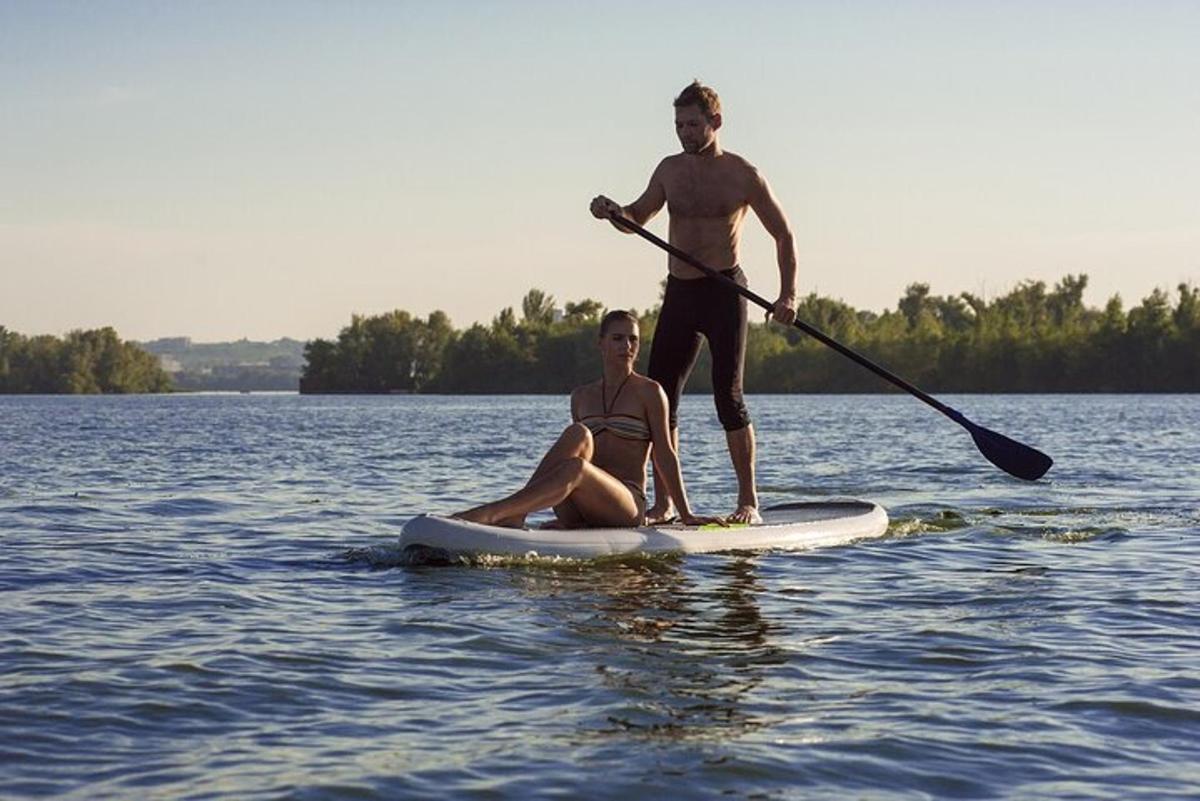 a man and a woman on a paddle board in the water