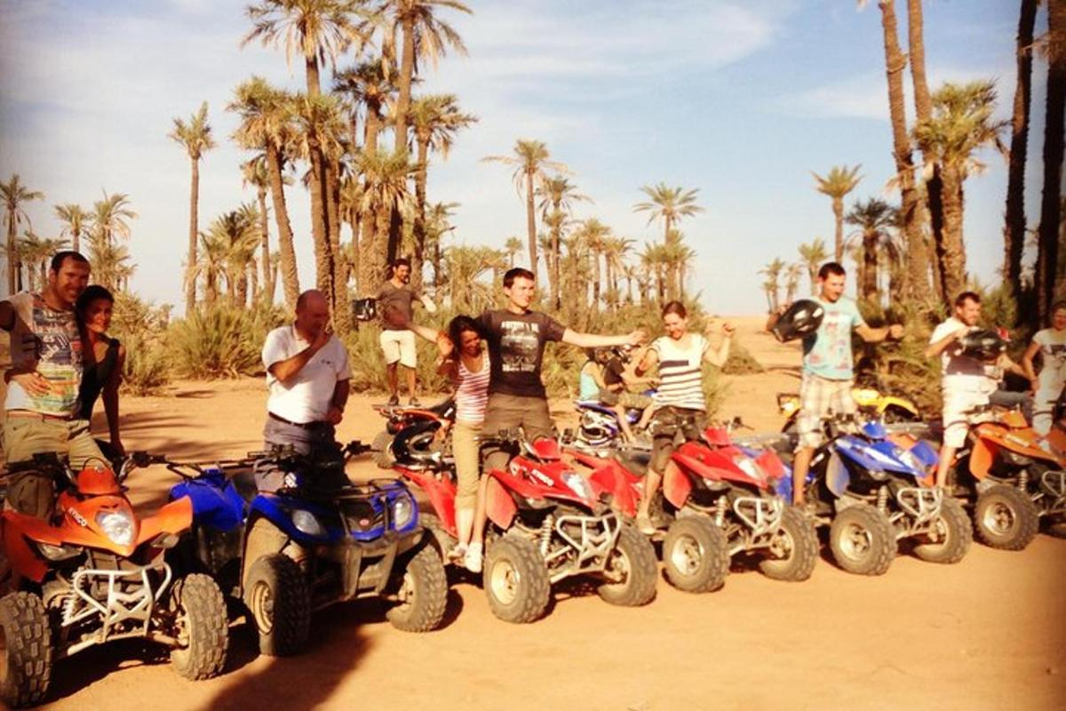 a group of people standing around atvs in the dirt