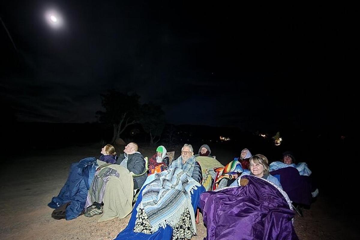 a group of people wrapped in blankets in the dark