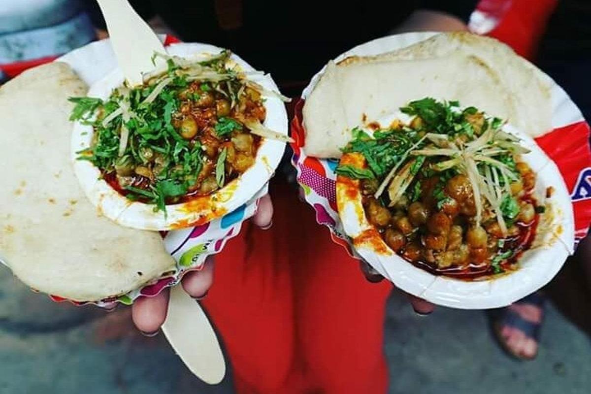 two people holding two food items in their hands