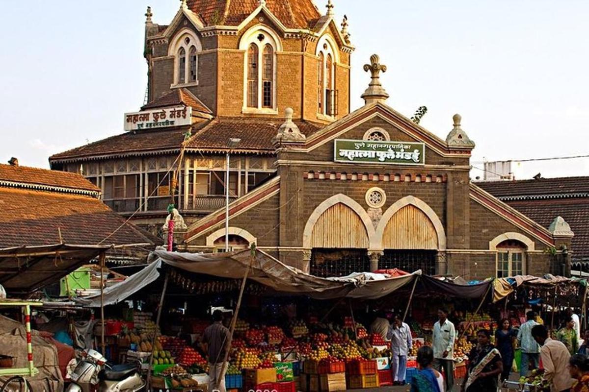 a market in front of a building with a clock tower